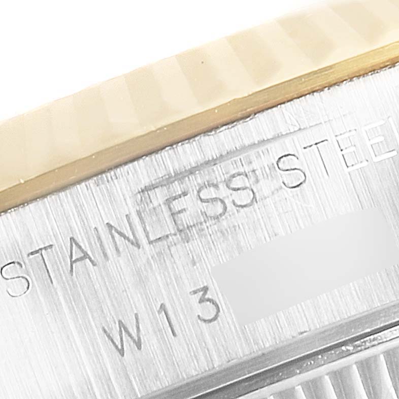 Close-up of the case side and bezel edge of a Rolex Datejust 69173 Women
s Steel and Gold (two tone) Silver Dial 69173 Women
s Steel and Gold (two tone) Silver Dial, showing "STAINLESS STEEL" engraving.