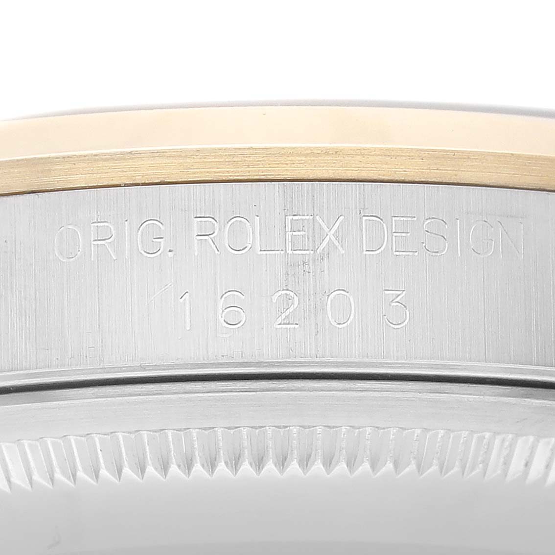 The image shows a close-up of the case side of a Rolex Datejust 16203 Men's Steel and Gold (two tone) Grey Dial 16203 Men's Steel and Gold (two tone) Grey Dial model, revealing the engraved model number 16203.