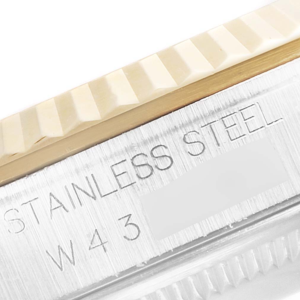 Close-up angle showing the fluted bezel and part of the stainless steel casing of a Rolex Datejust 16233 Men's Steel and Gold (two tone) Blue Dial 16233 Men's Steel and Gold (two tone) Blue Dial watch.