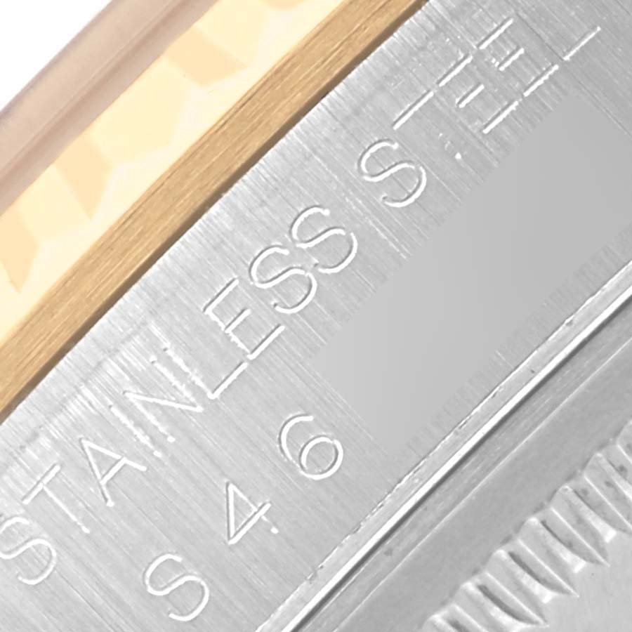 The image shows a close-up of the bezel and side of a Rolex Datejust 16233 Men
s Steel and Gold (two tone) White Dial 16233 Men
s Steel and Gold (two tone) White Dial watch, highlighting the "STAINLESS STEEL" engraving.