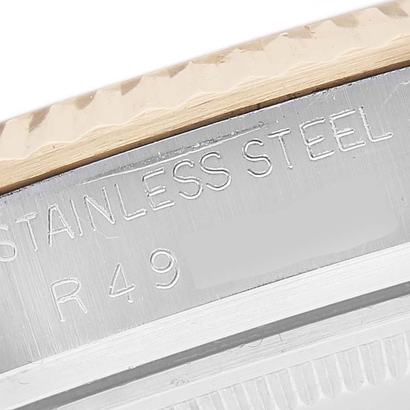 This image shows a close-up of the side of the Rolex Vintage Collection 16013 Men's Steel and Gold (two tone) White Dial 16013 Men's Steel and Gold (two tone) White Dial watch, highlighting the stainless steel bezel and engraved text.