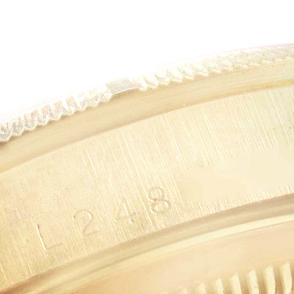 This image shows a close-up angle of the engraved serial number on the case back of a Rolex Datejust 16248 Men's Yellow Gold Champagne Dial 16248 Men's Yellow Gold Champagne Dial watch.