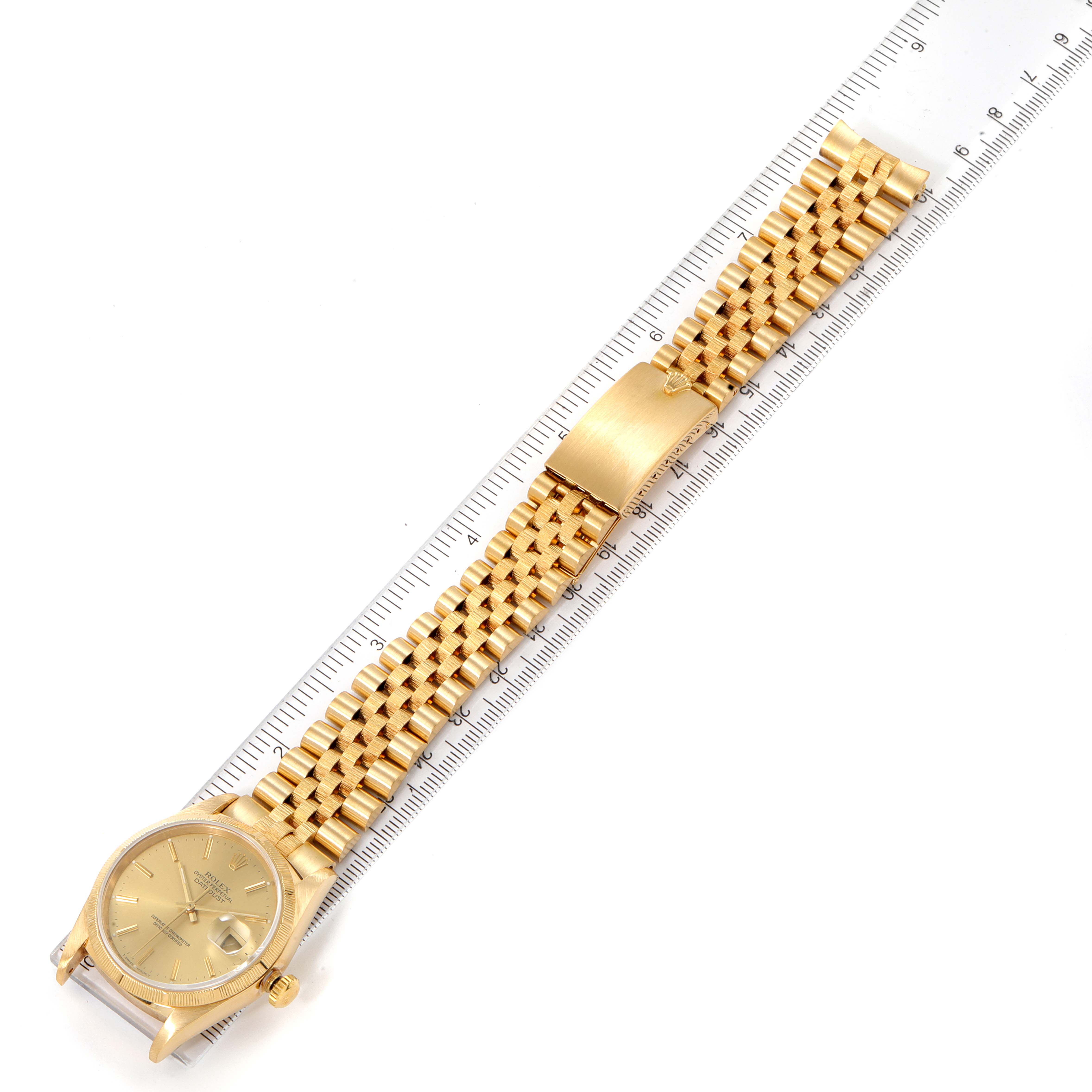 The image shows a Rolex Datejust 16248 Men's Yellow Gold Champagne Dial 16248 Men's Yellow Gold Champagne Dial watch laid flat with its gold bracelet and clasp fully extended alongside a ruler.