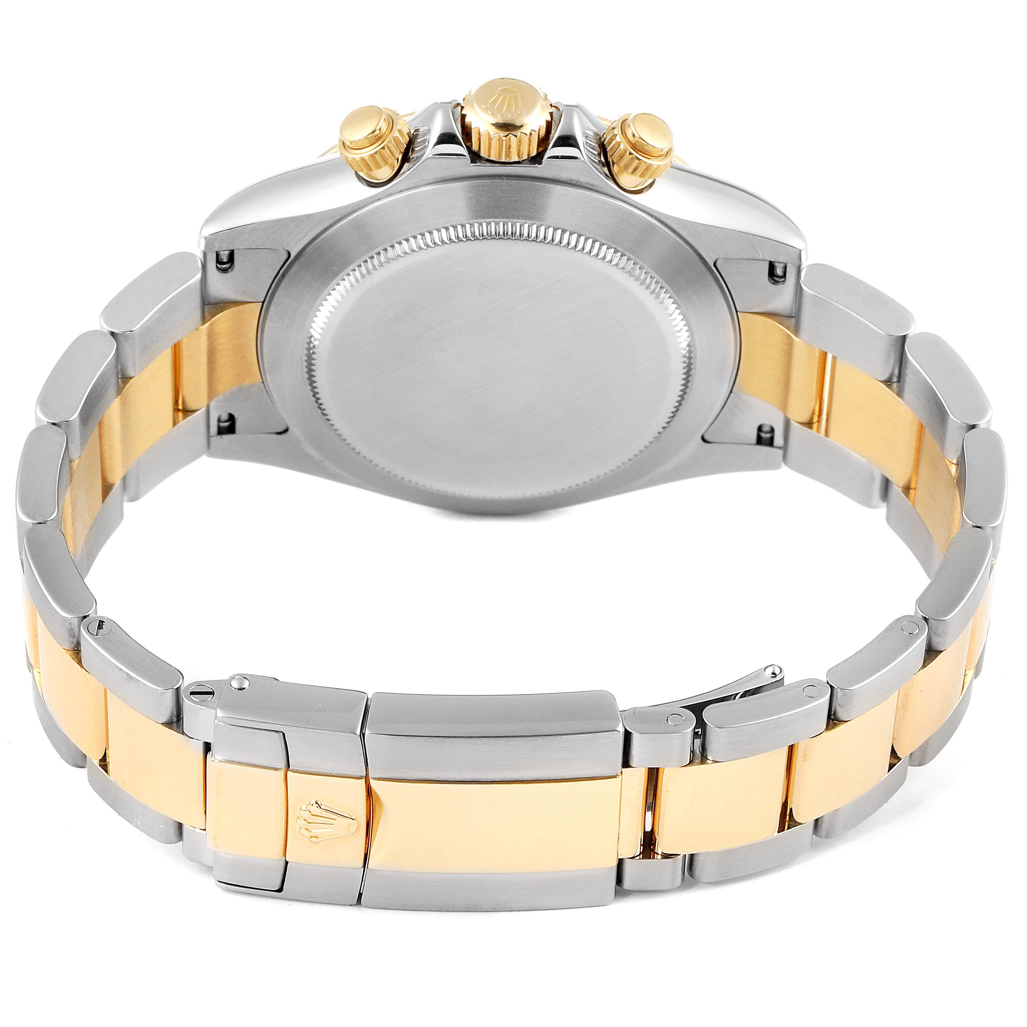 The image shows the back case and bracelet of a Rolex Daytona 116523 Men's Steel and Gold (two tone) Grey Dial 116523 Men's Steel and Gold (two tone) Grey Dial watch, highlighting the crown and pushers on the side.