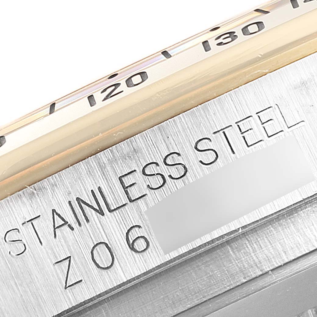 The image shows a close-up angle of the case side, bezel, and engraved text on a Rolex Daytona 116523 Men's Steel and Gold (two tone) Grey Dial 116523 Men's Steel and Gold (two tone) Grey Dial watch.