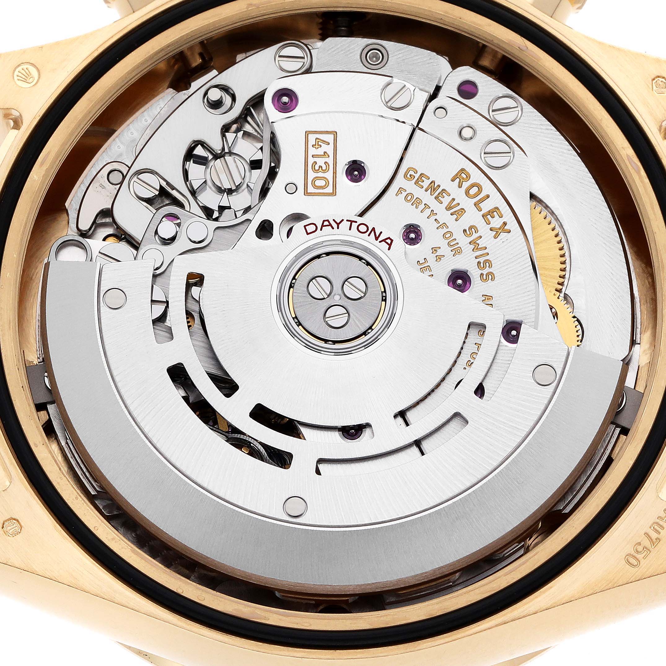 The image shows the movement of the Rolex Daytona 116508 Men's Yellow Gold Green Dial watch from the back, highlighting gears and inscriptions.