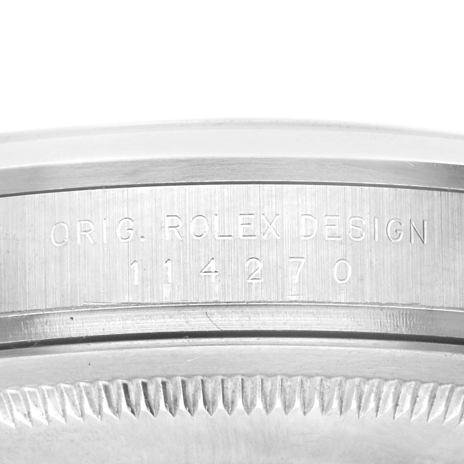 The image shows a close-up of the engraving on the side of the bezel of a Rolex Explorer 114270 Men's Stainless Steel Black Dial 114270 Men's Stainless Steel Black Dial watch.