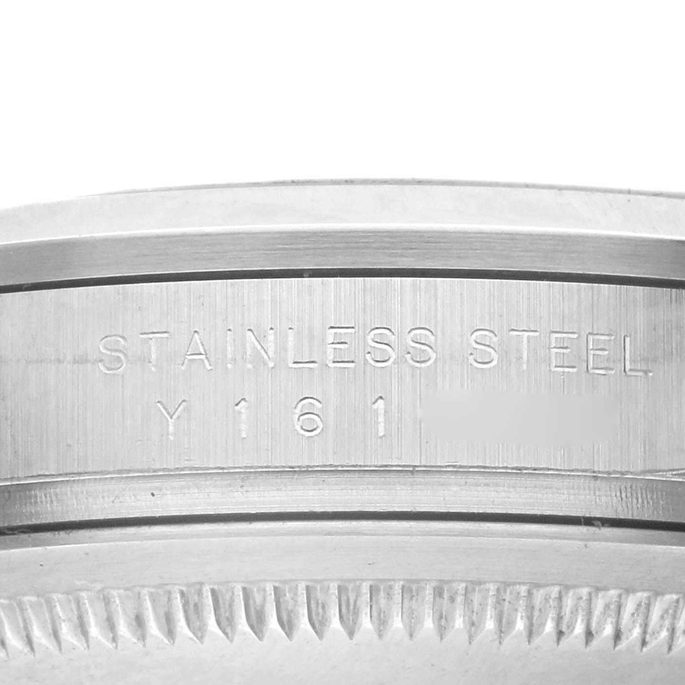 The image shows a close-up of the Rolex Explorer 114270 Men's Stainless Steel Black Dial 114270 Men's Stainless Steel Black Dial's stainless steel case with serial engraving.