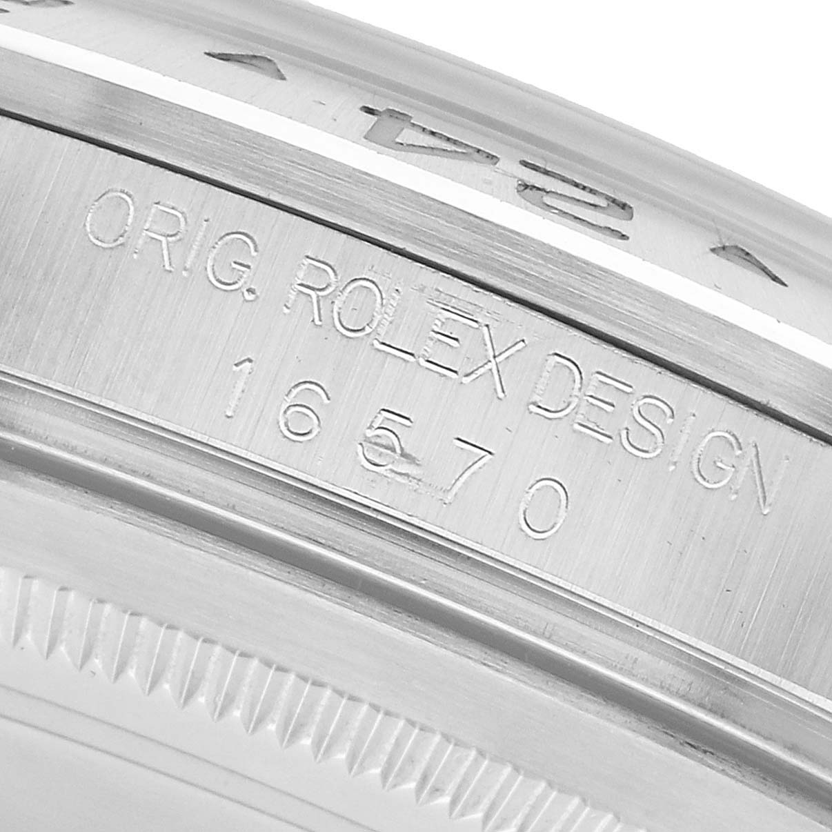 The image shows a close-up angle of the edge of a Rolex Explorer 16570 Men's Stainless Steel White Dial watch case, highlighting the engraved model number and "ORIG ROLEX DESIGN."