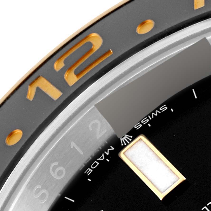 The image shows a close-up of the bezel and part of the dial of a Rolex GMT-Master 126713GRNR Men's Steel and Gold (two tone) Black Dial 126713GRNR Men's Steel and Gold (two tone) Black Dial watch.