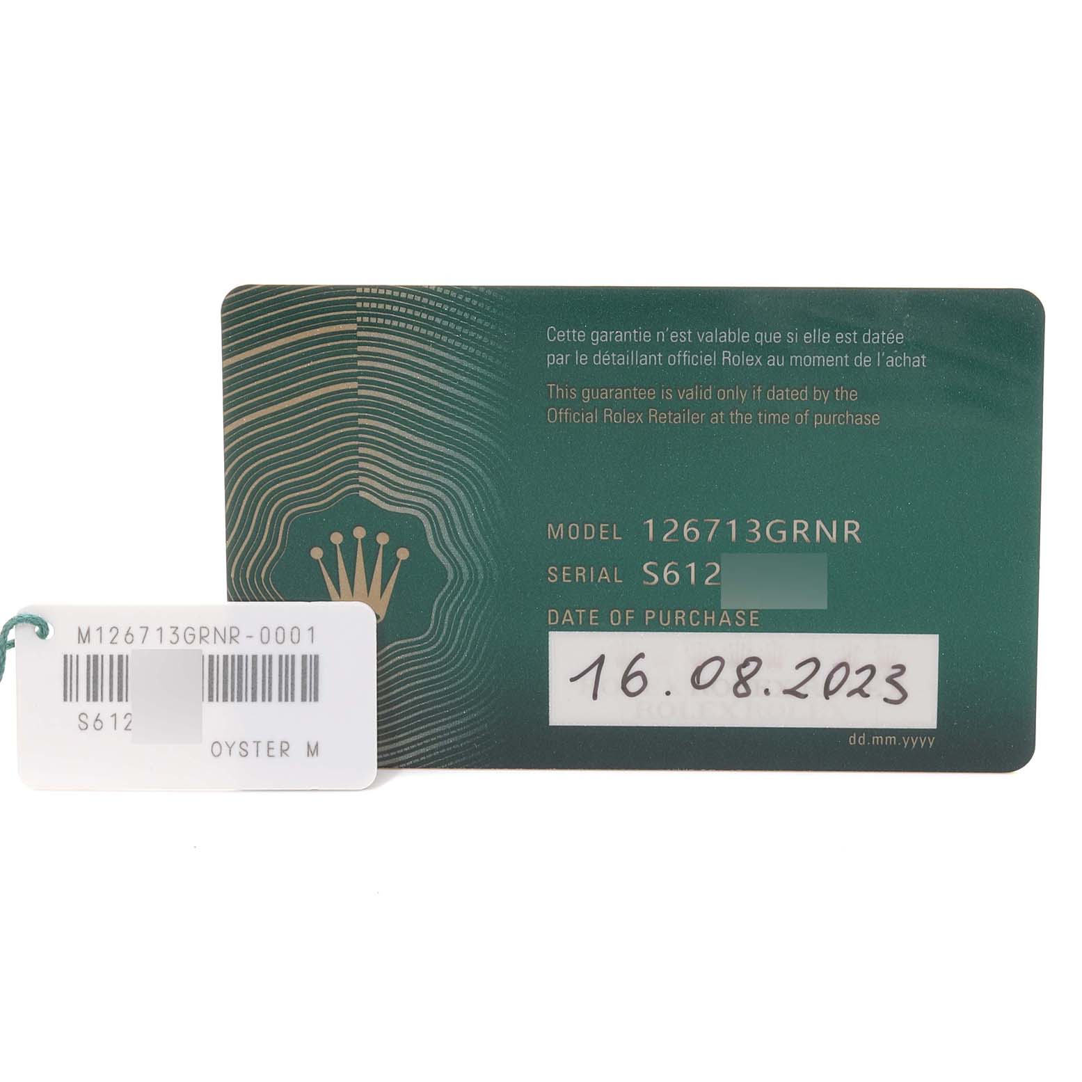 This image shows a warranty card and a tag for a Rolex GMT-Master 126713GRNR Men's Steel and Gold (two tone) Black Dial 126713GRNR Men's Steel and Gold (two tone) Black Dial model 126713GRNR watch.