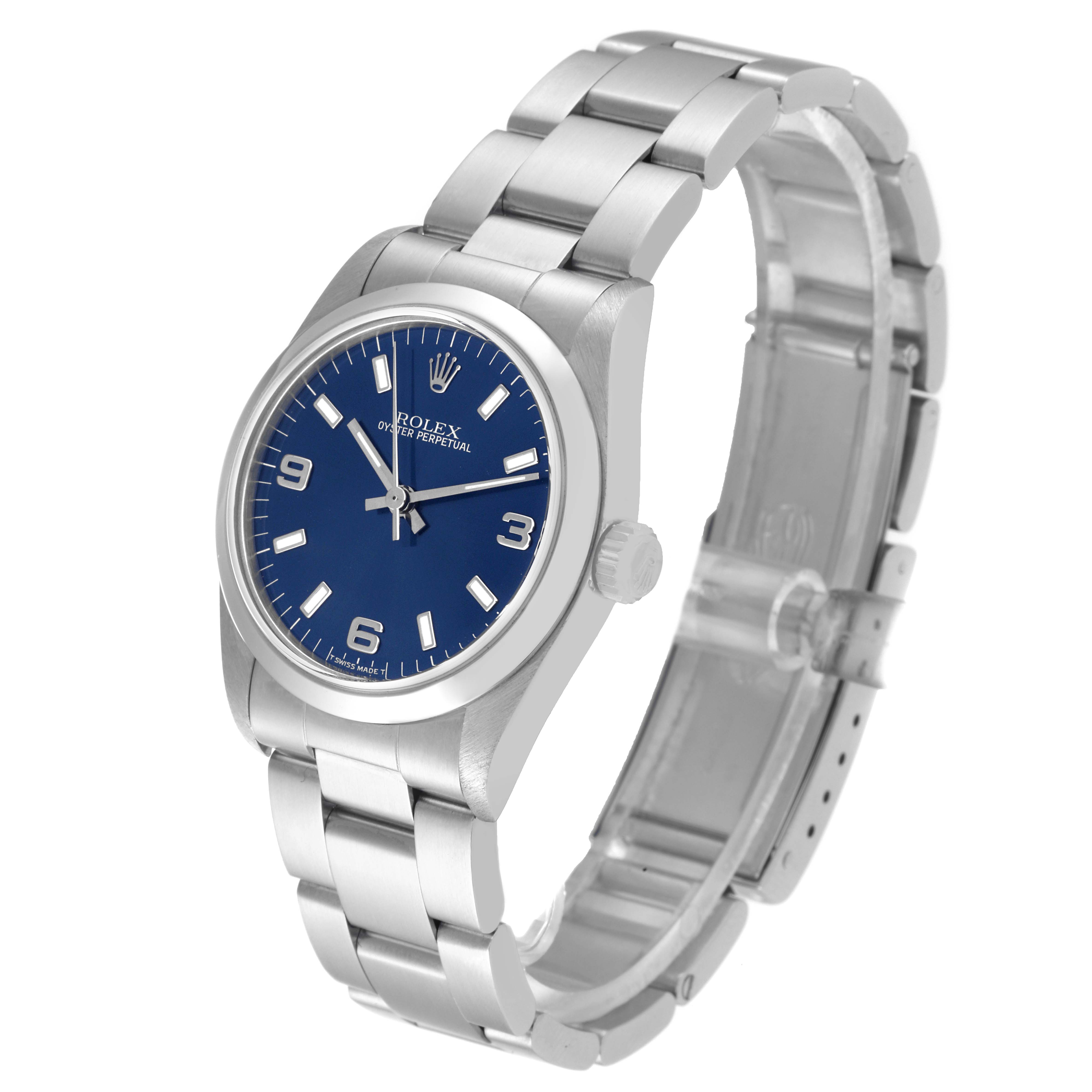 The image shows a Rolex Mid-Size 67480 Women
s Stainless Steel Blue Dial 67480 Women
s Stainless Steel Blue Dial watch with a blue dial, silver hour markers, and steel bracelet angled from the top-left side.
