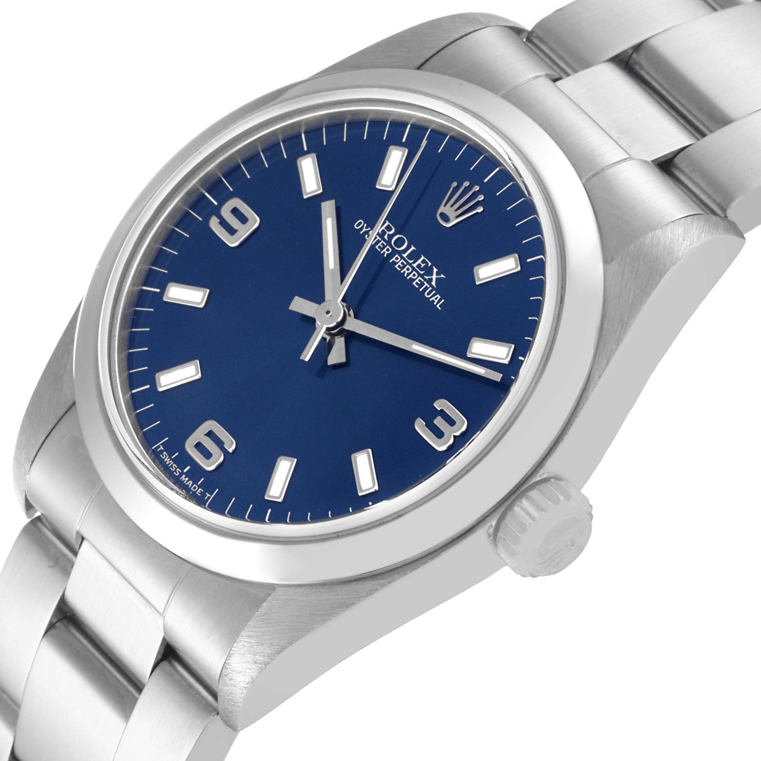 The image shows a Rolex Mid-Size 67480 Women
s Stainless Steel Blue Dial 67480 Women
s Stainless Steel Blue Dial watch at an oblique angle, highlighting the blue dial, crown, and stainless steel bracelet.