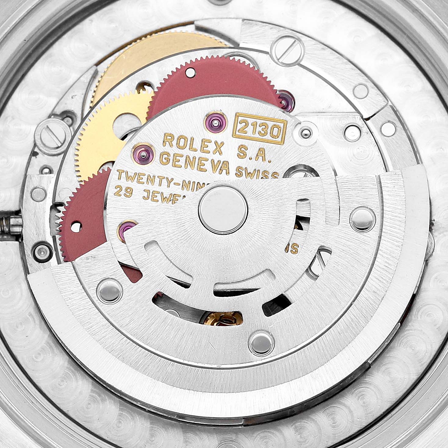 The image shows the internal mechanism of a Rolex Mid-Size 67480 Women
s Stainless Steel Blue Dial 67480 Women
s Stainless Steel Blue Dial watch, highlighting gear wheels and engravings.