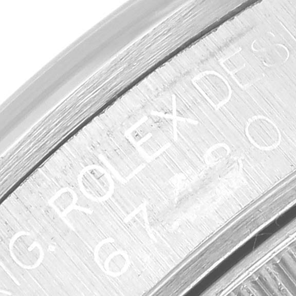 This image shows an engraved inner bezel of a Mid-Size Rolex watch, highlighting the brand and model details.