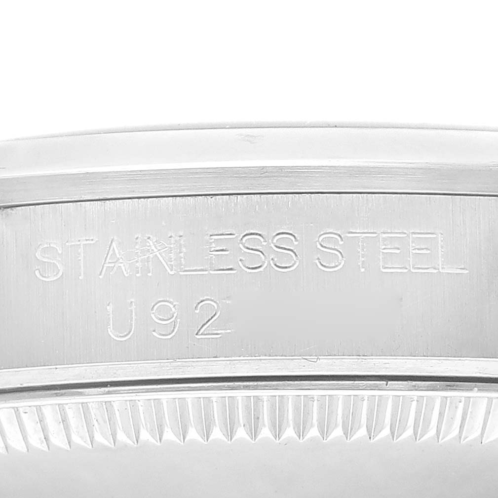 This image shows a close-up of the side of a mid-size Rolex watch case, with "STAINLESS STEEL" engraved on it.