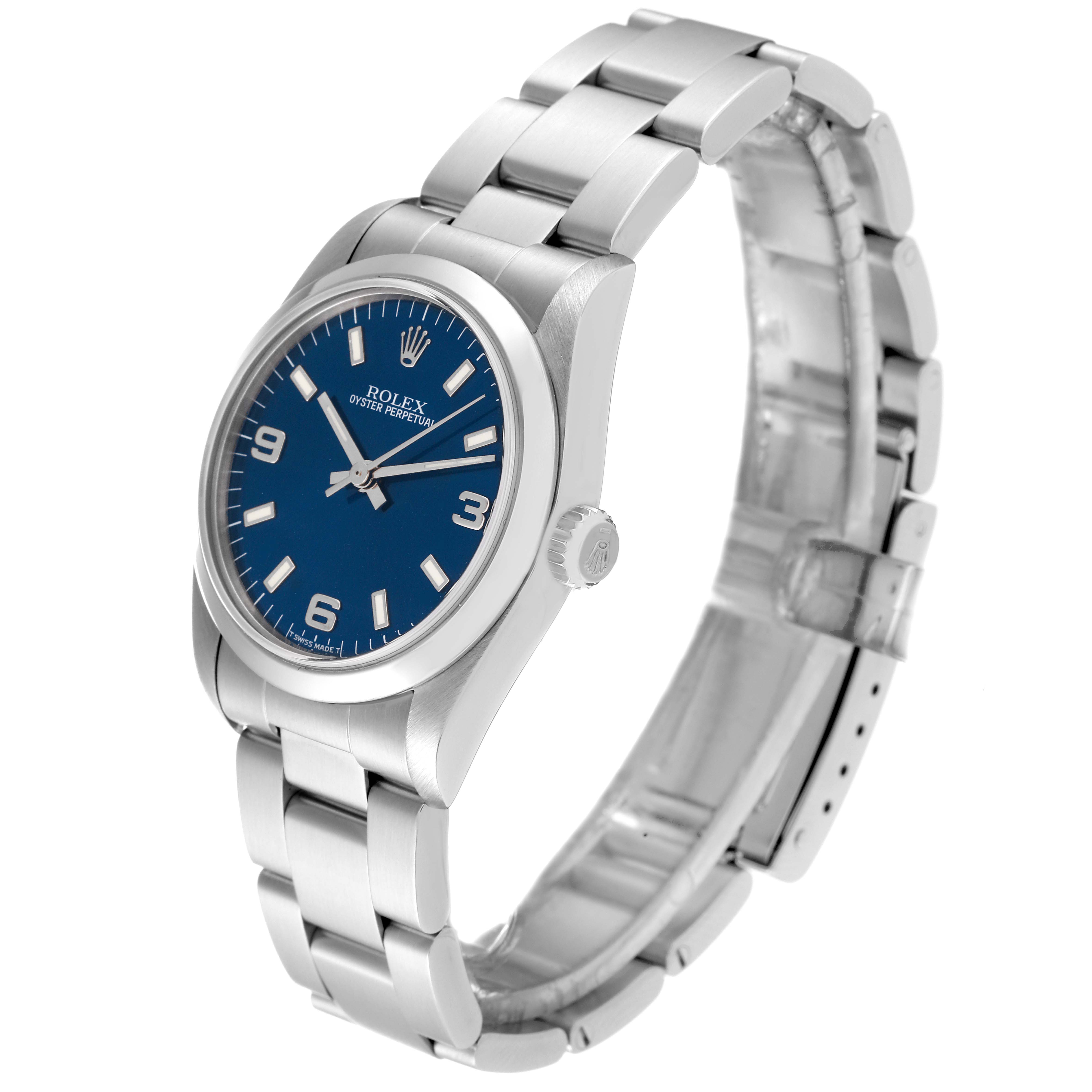 The Rolex Mid-Size 67480 Women
s Stainless Steel Blue Dial 67480 Women
s Stainless Steel Blue Dial Oyster Perpetual watch is shown from a three-quarter angle, displaying the dial, case, crown, and part of the bracelet.