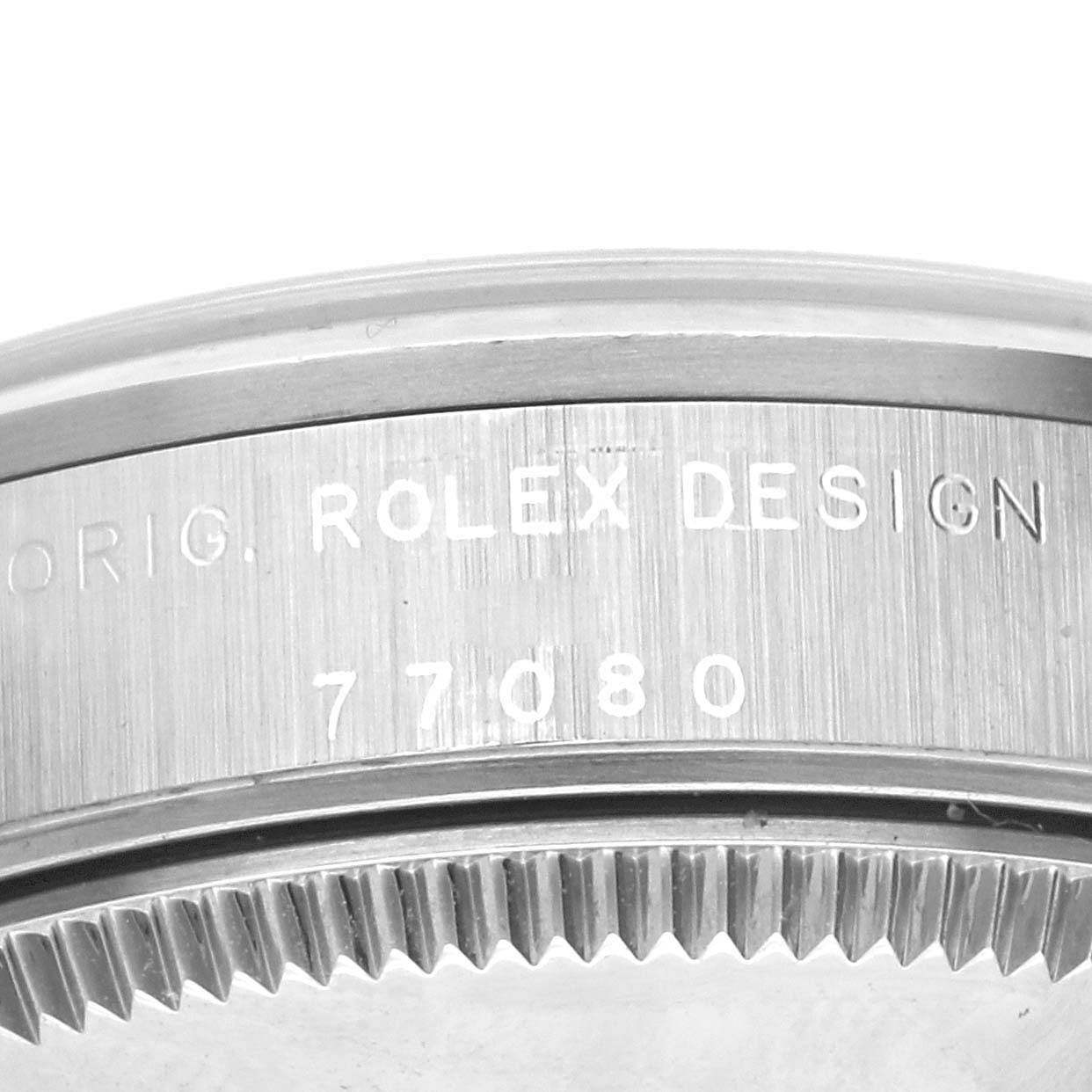 The image shows the side profile of a Rolex Mid-Size 77080 Women's Stainless Steel Black Dial 77080 Women's Stainless Steel Black Dial model, focusing on the engraved bezel with design and model numbers.