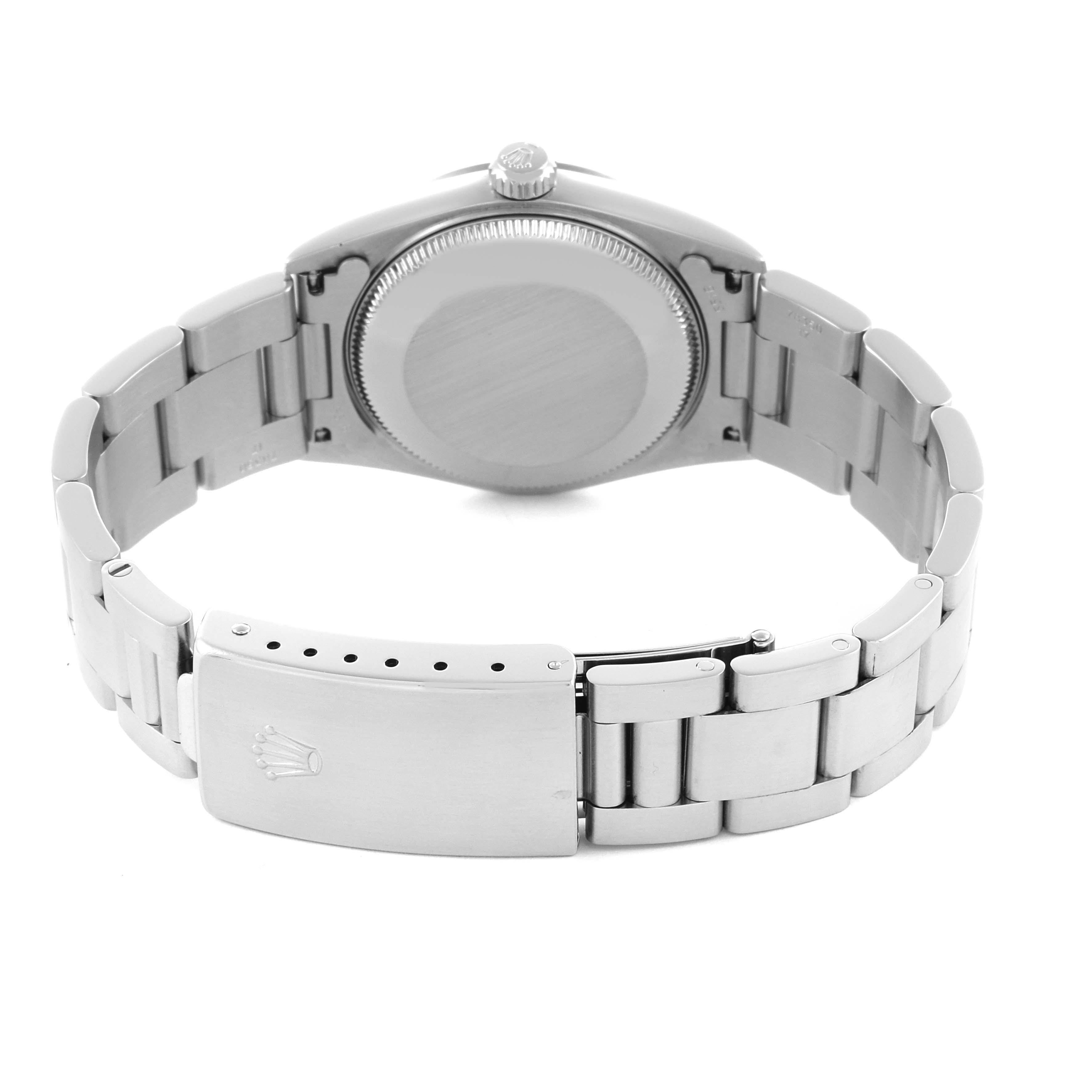 The image shows the back view of a Rolex Mid-Size 77080 Women's Stainless Steel Black Dial 77080 Women's Stainless Steel Black Dial watch, highlighting the case back and bracelet clasp.