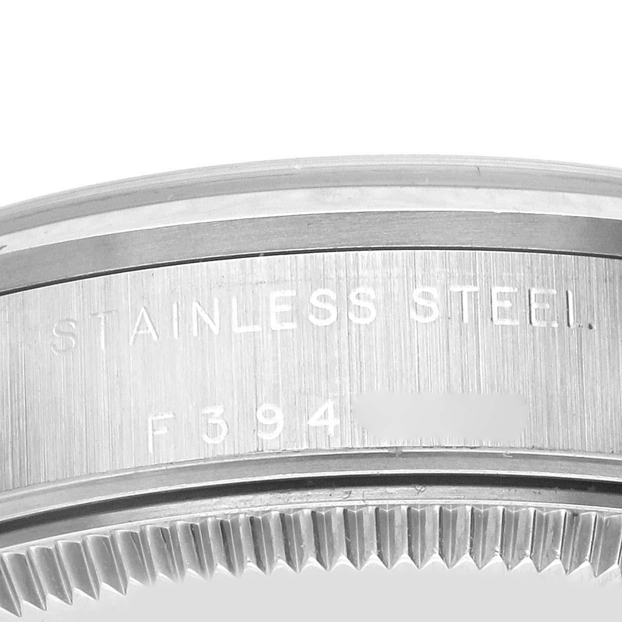 The image shows the side of a Rolex Mid-Size 77080 Women's Stainless Steel Black Dial 77080 Women's Stainless Steel Black Dial watch, featuring the stainless steel casing and partial serial number.