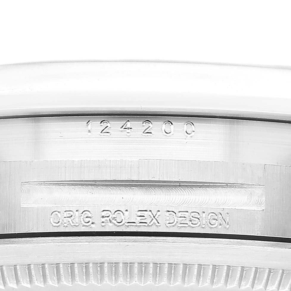 This image shows the side of the case of a Rolex Oyster Perpetual 124200 Men
s Stainless Steel Blue Dial 124200 Men
s Stainless Steel Blue Dial, displaying the model number and "ORIG ROLEX DESIGN" engraving.