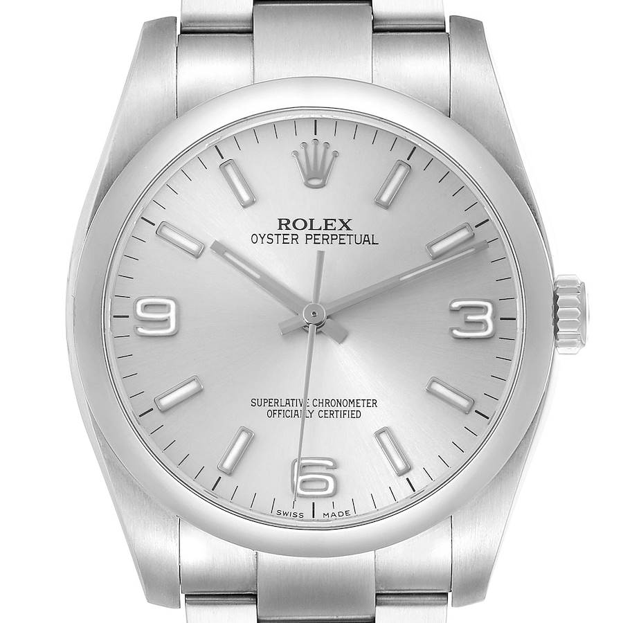 The Rolex Oyster Perpetual watch is shown from a top-down angle, highlighting the dial, bezel, and part of the bracelet.