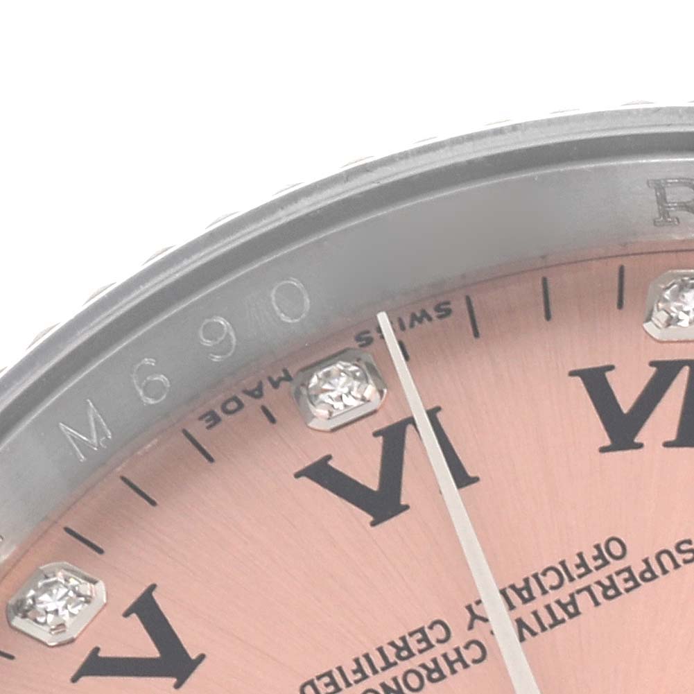 The image shows a close-up of the dial and bezel edge of a Rolex Oyster Perpetual 116034 Men's Stainless Steel Pink Dial 116034 Men's Stainless Steel Pink Dial watch, highlighting numbering and markers.