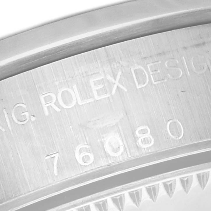 The image shows a close-up of the engraved case back of a Rolex Oyster Perpetual 76080 Women's Stainless Steel Black Dial 76080 Women's Stainless Steel Black Dial, highlighting the model number.