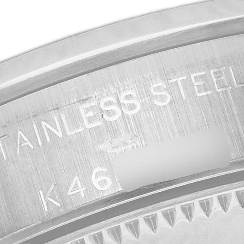 The image shows a close-up of the back case engraving on the Rolex Oyster Perpetual 76080 Women's Stainless Steel Black Dial 76080 Women's Stainless Steel Black Dial, highlighting the stainless steel text.