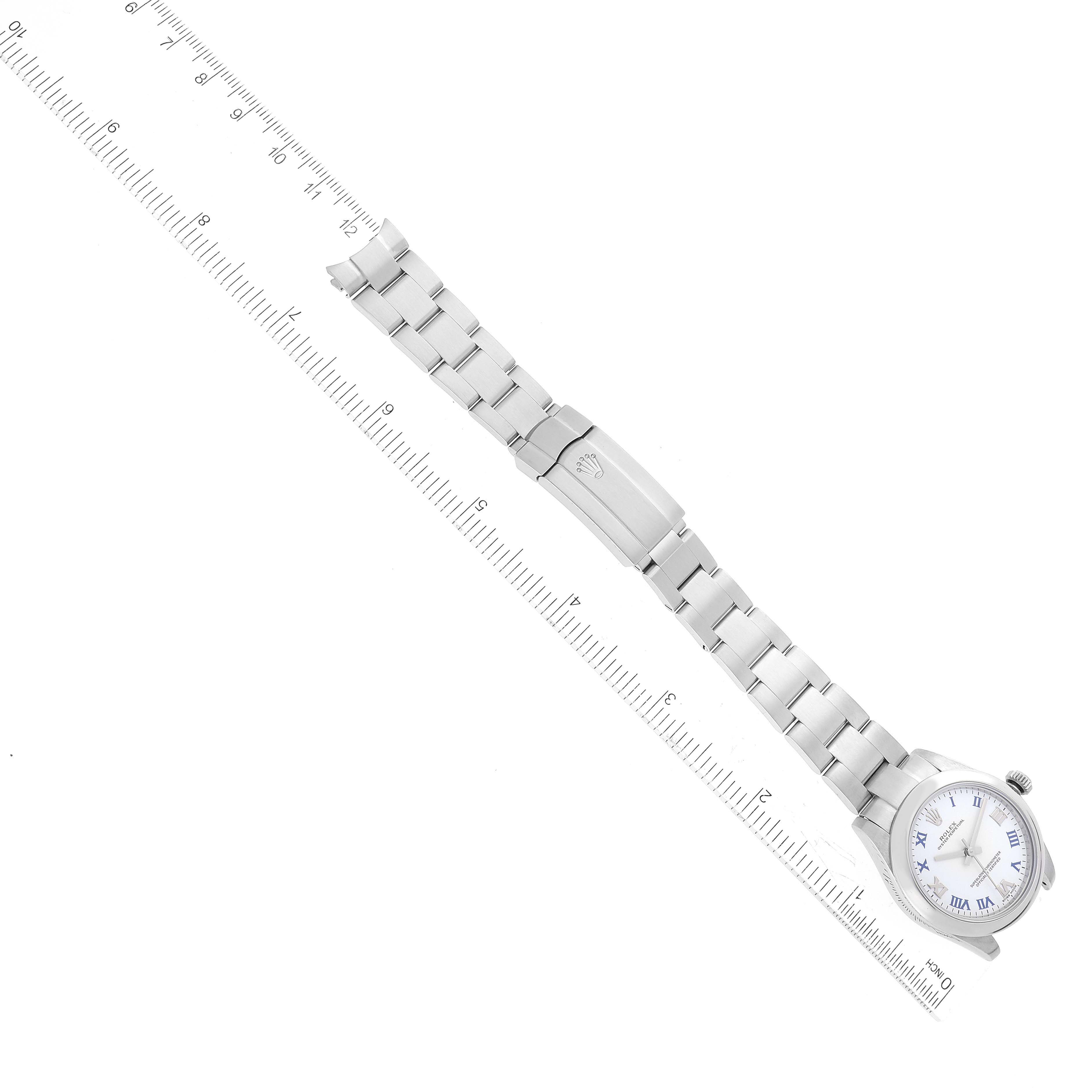 This image shows a Rolex Mid-Size 177200 Women's Stainless Steel White Dial 177200 Women's Stainless Steel White Dial watch positioned diagonally with the band fully extended alongside a ruler for scale.