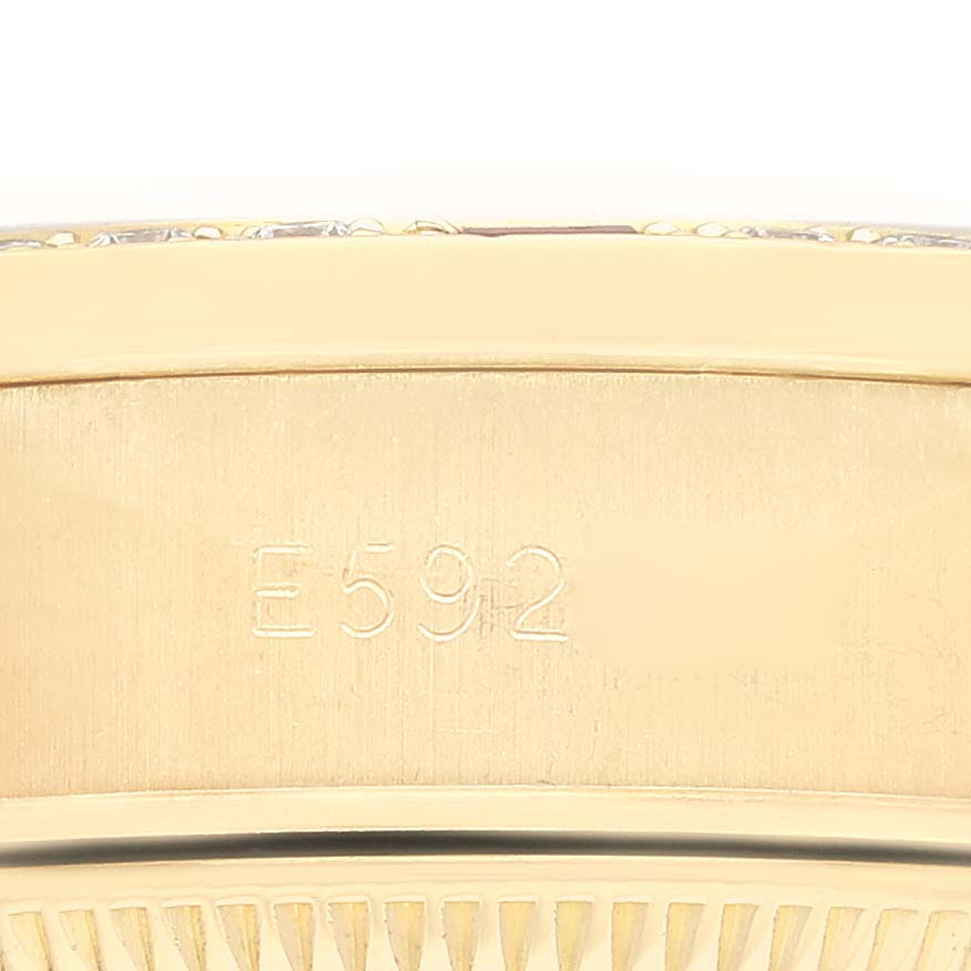 This close-up image of a Rolex President 69068 Women's Yellow Gold Champagne Dial 69068 Women's Yellow Gold Champagne Dial watch shows the engraved serial number on the watch band.