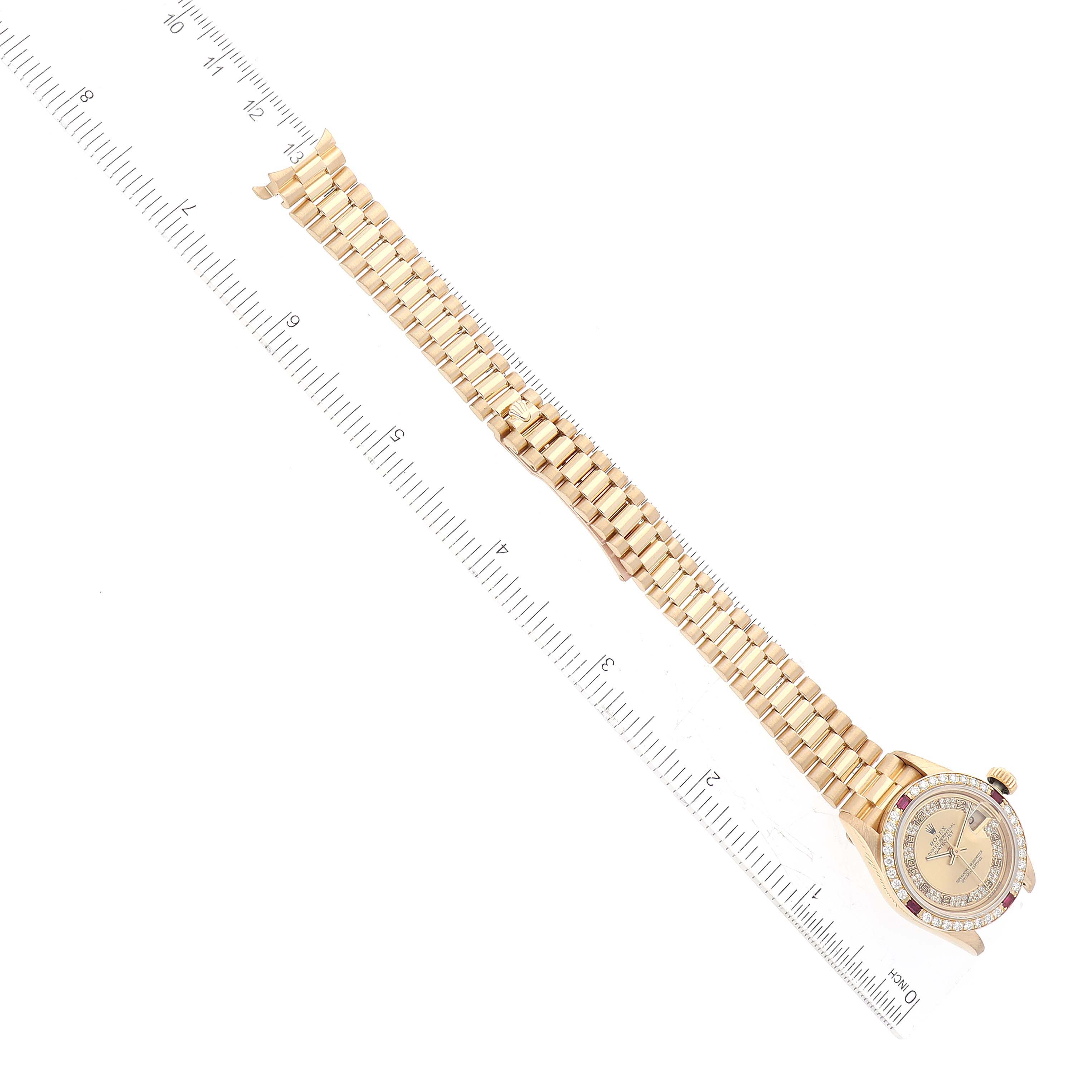 The image shows a top-down view of a Rolex President 69068 Women's Yellow Gold Champagne Dial 69068 Women's Yellow Gold Champagne Dial model watch, including its face and bracelet, next to a ruler.