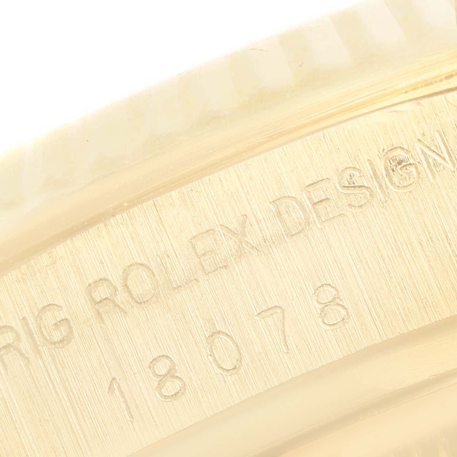 This image shows a close-up of the engraved serial number and design mark on the gold casing of a Rolex President 18078 Men
s Yellow Gold Black Dial 18078 Men
s Yellow Gold Black Dial model watch.