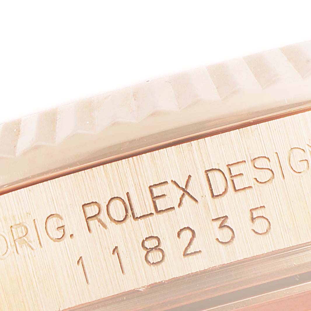 This close-up image shows the engraved bezel and serial number of the Rolex President 118235 Men's Rose Gold Mother of Pearl Dial 118235 Men's Rose Gold Mother of Pearl Dial model watch.