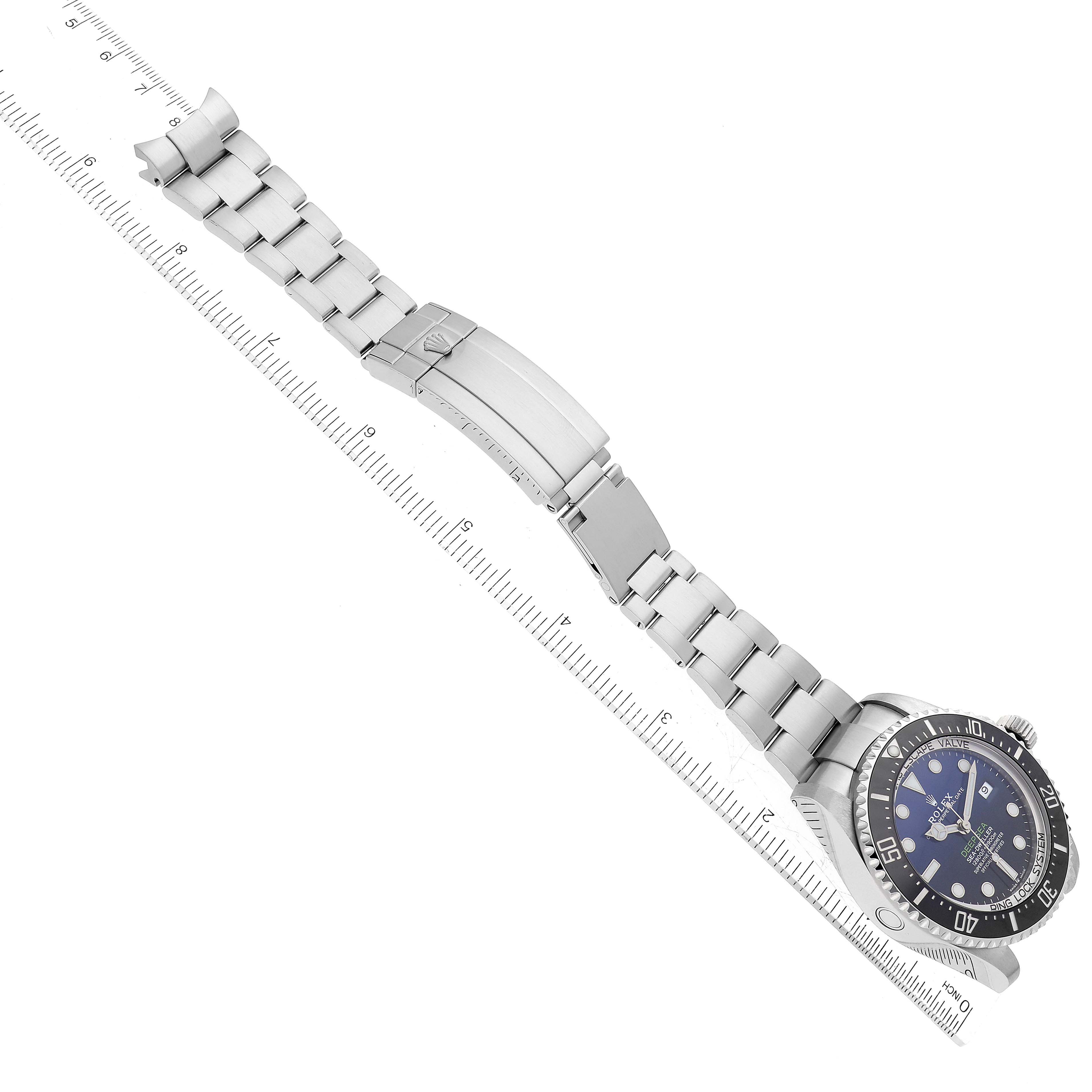 The image shows a top-down view of a Rolex Sea-Dweller 126660 Men's Stainless Steel Blue Dial 126660 Men's Stainless Steel Blue Dial watch, highlighting the face and unfolded metal bracelet.