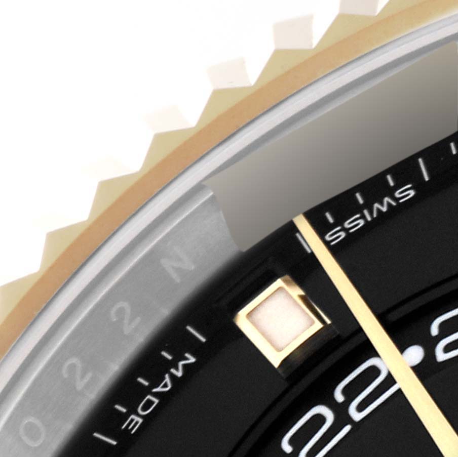 This close-up image shows the bezel and a portion of the dial of the Rolex Sky-Dweller 326933 Men
s Steel and Gold (two tone) Black Dial 326933 Men
s Steel and Gold (two tone) Black Dial watch.