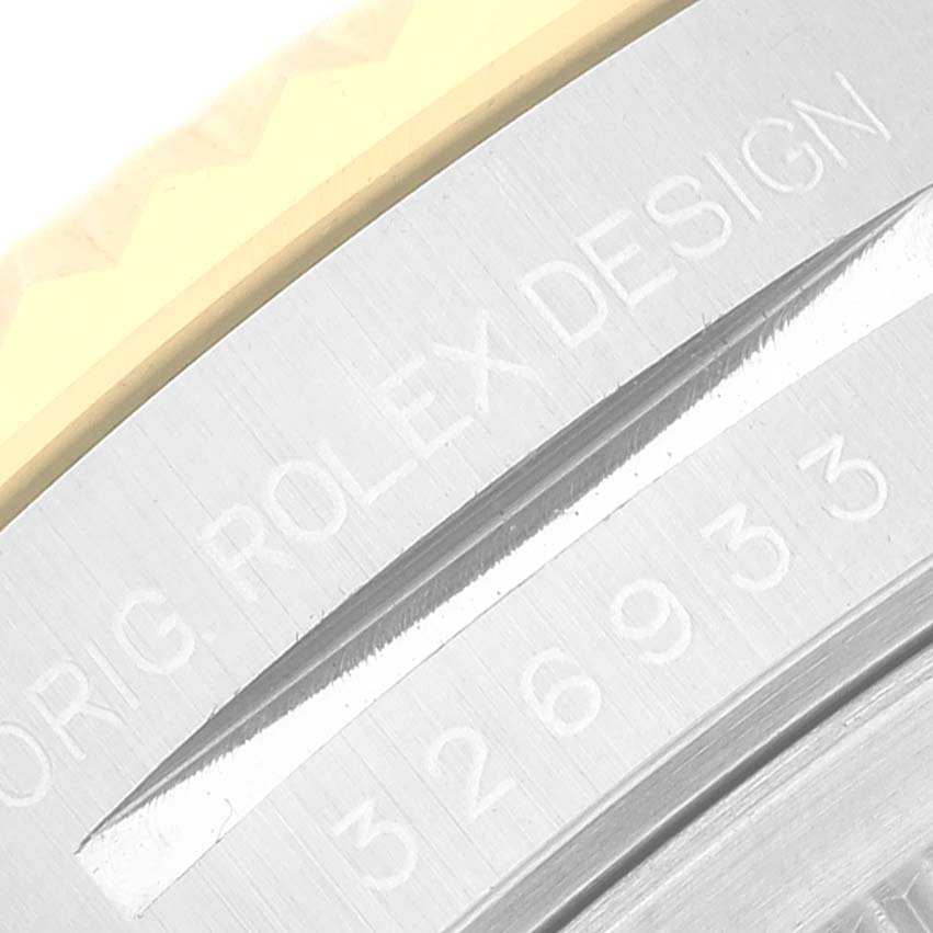 The image shows a close-up view of the engraving on the case back of a Rolex Sky-Dweller 326933 Men
s Steel and Gold (two tone) Black Dial 326933 Men
s Steel and Gold (two tone) Black Dial watch.