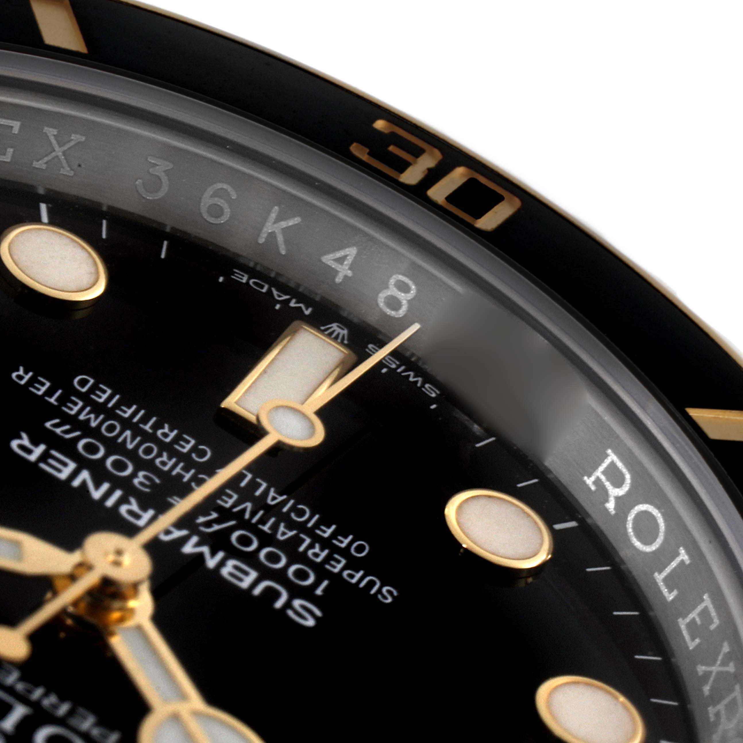 Close-up of a Rolex Submariner 126613 Men's Steel and Gold (two tone) Black Dial 126613 Men's Steel and Gold (two tone) Black Dial watch face, highlighting part of the bezel, dial, and text.