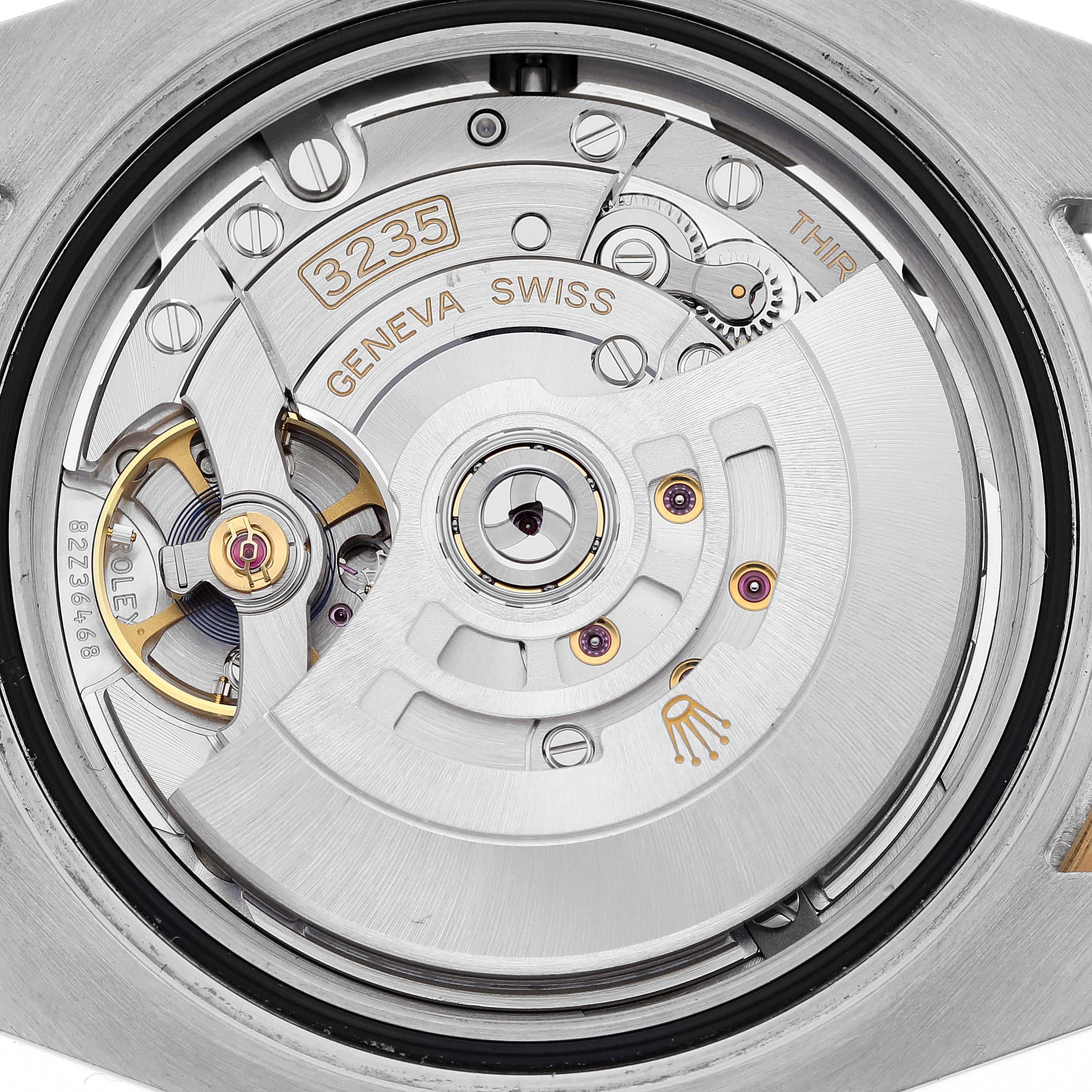 This image shows the intricate internal movement of a Rolex Submariner 126613LB Men's Steel and Gold (two tone) Blue Dial 126613LB Men's Steel and Gold (two tone) Blue Dial watch, including the rotor and gear components.