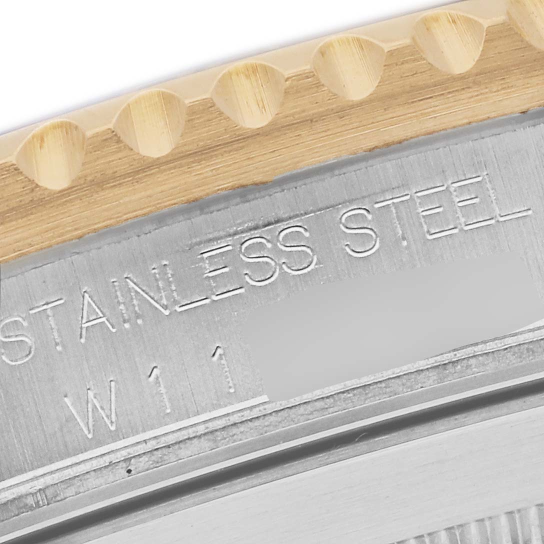 The image shows a close-up of the Rolex Submariner 16613 Men's Steel and Gold (two tone) Blue Dial 16613 Men's Steel and Gold (two tone) Blue Dial's bezel edge and part of its case stamping.