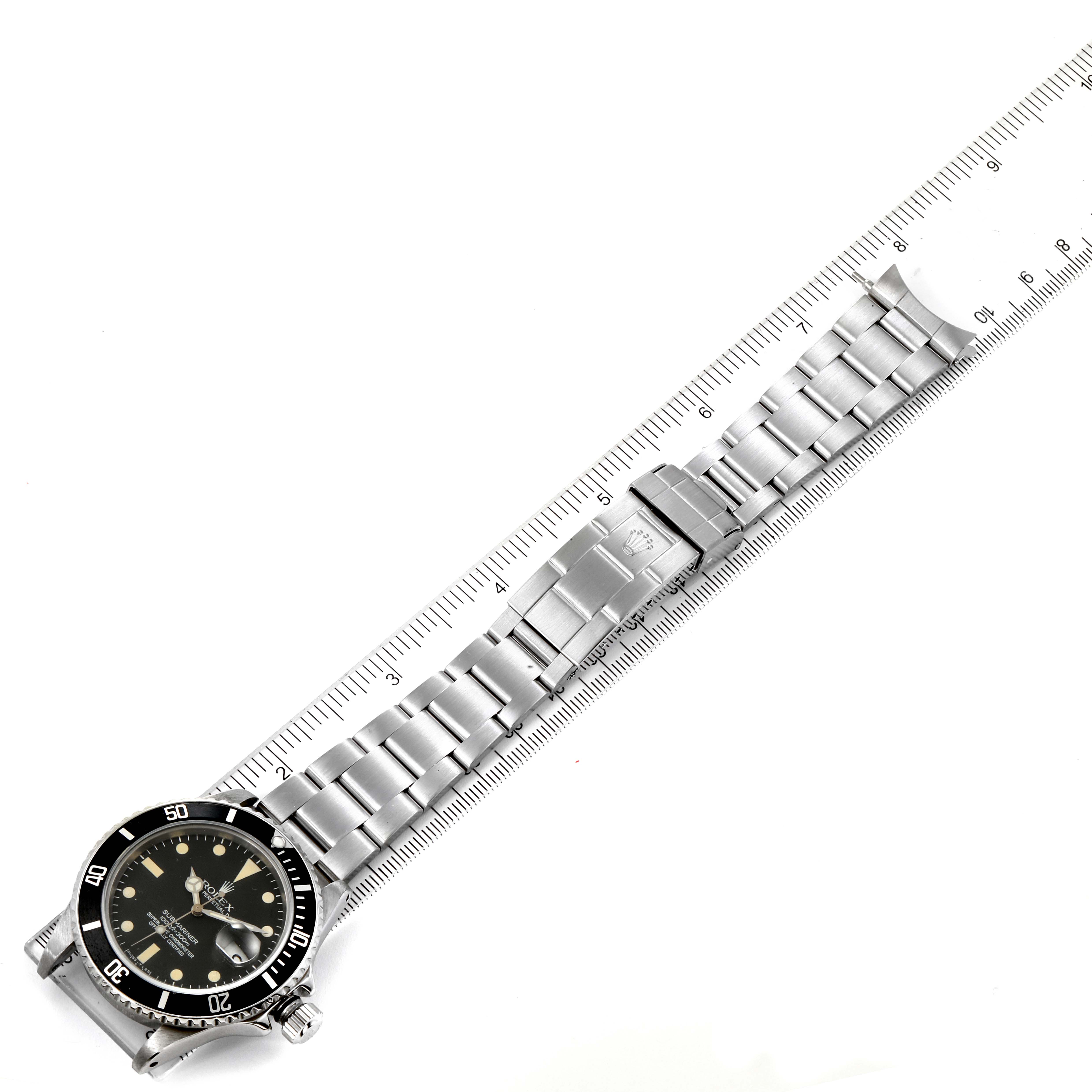 The image shows a Rolex Vintage Collection 16800 Men's Stainless Steel Black Dial 16800 Men's Stainless Steel Black Dial watch laid flat with a stainless steel bracelet next to a ruler for size reference.
