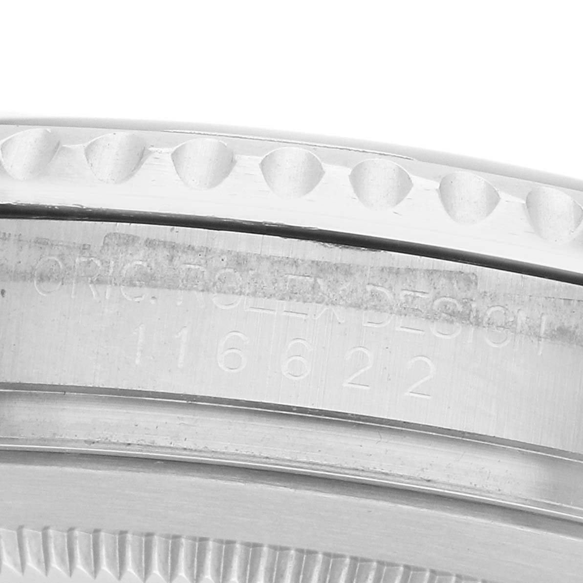 The image shows a close-up side view of the Rolex Yacht-Master 116622 Men's Stainless Steel Blue Dial's bezel and engraved edge, featuring its serial number.