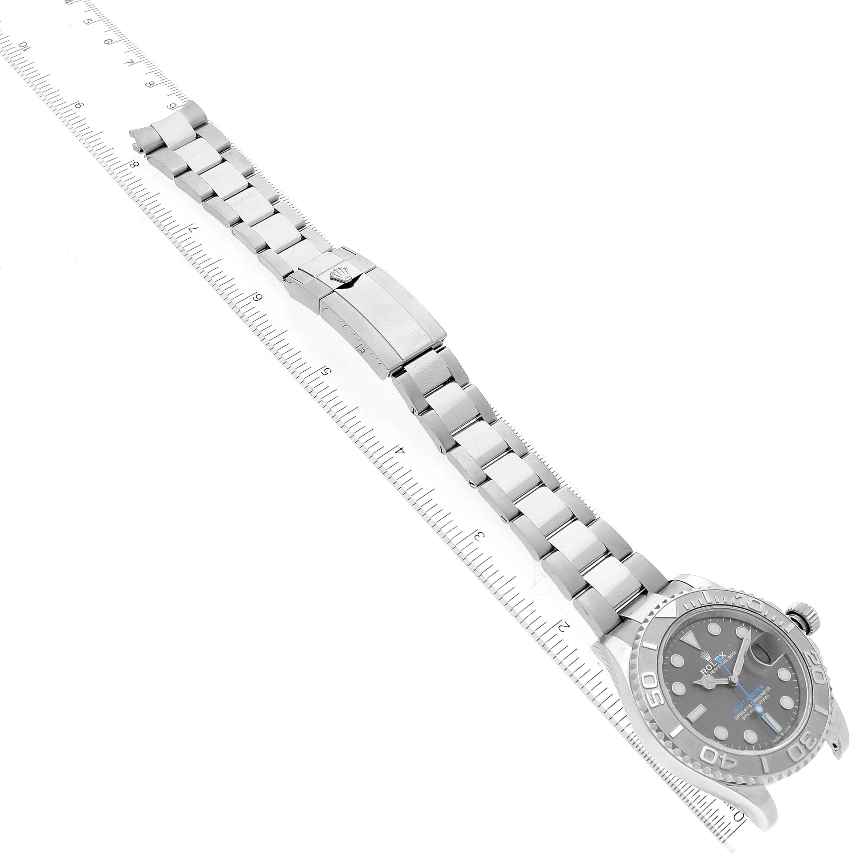 The image shows an overhead view of a Rolex Yacht-Master 126622 Men's Stainless Steel Grey Dial 126622 Men's Stainless Steel Grey Dial watch displaying the face, bezel, bracelet, and clasp alongside a ruler.