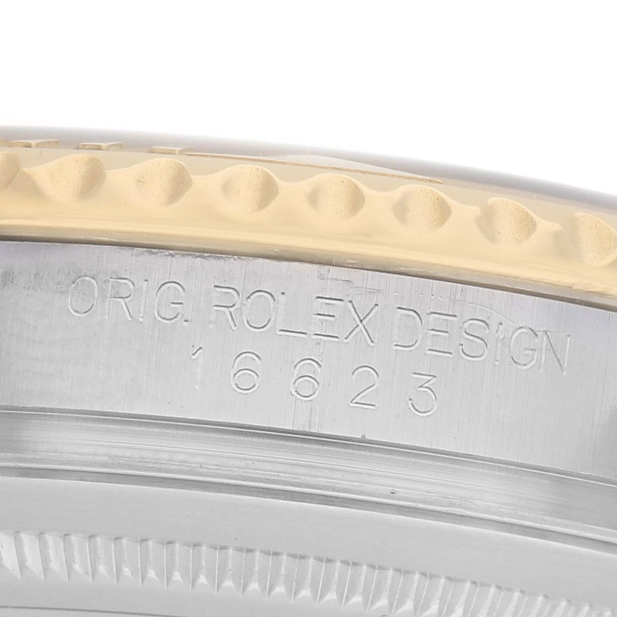 The image shows a close-up of the side of a Rolex Yacht-Master 16623 Men's Steel and Gold (two tone) Grey Dial, focusing on the engraved bezel and case markings.