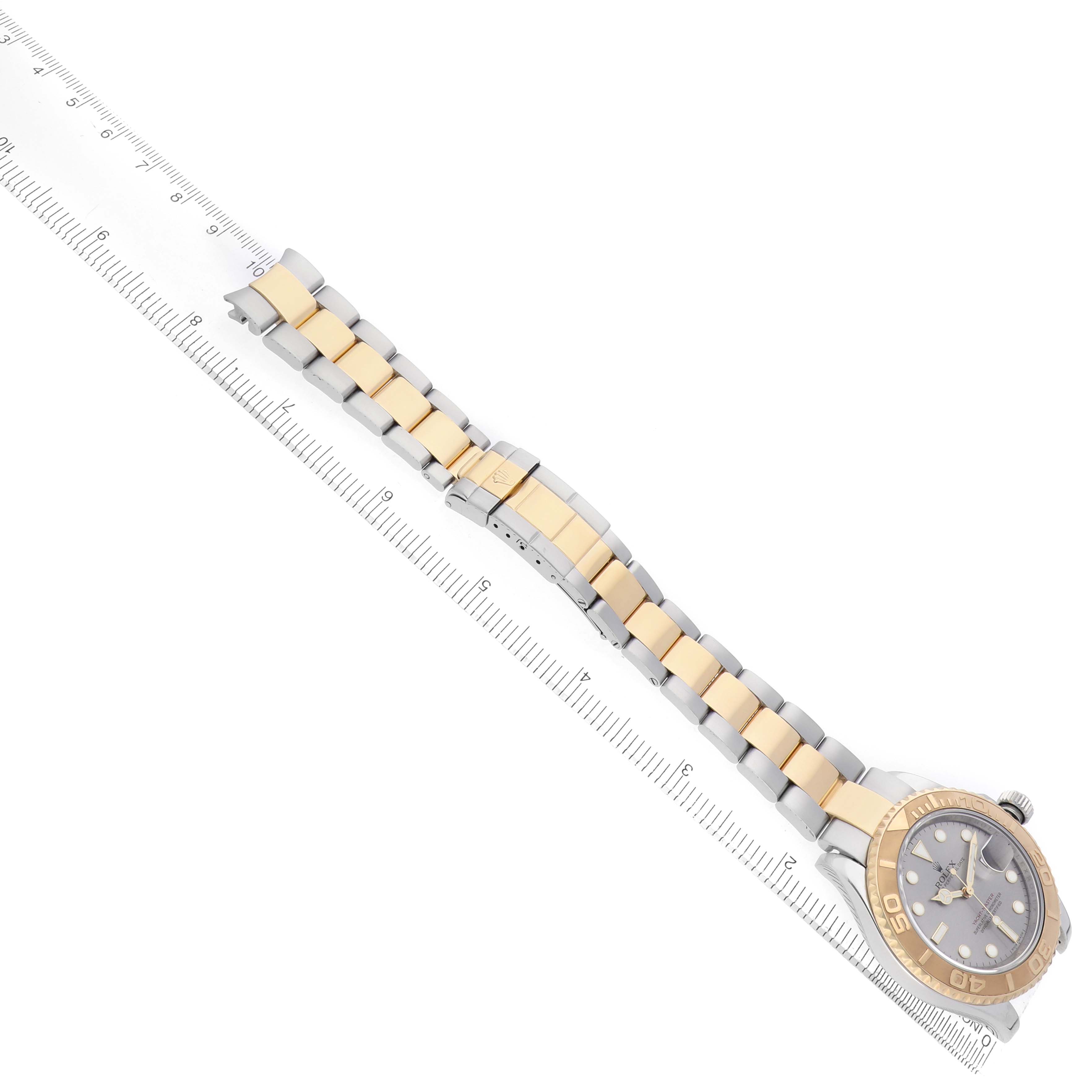 The Rolex Yacht-Master 16623 Men's Steel and Gold (two tone) Grey Dial watch is shown from a top view, featuring a two-tone bracelet, bezel, and dial with a ruler alongside.