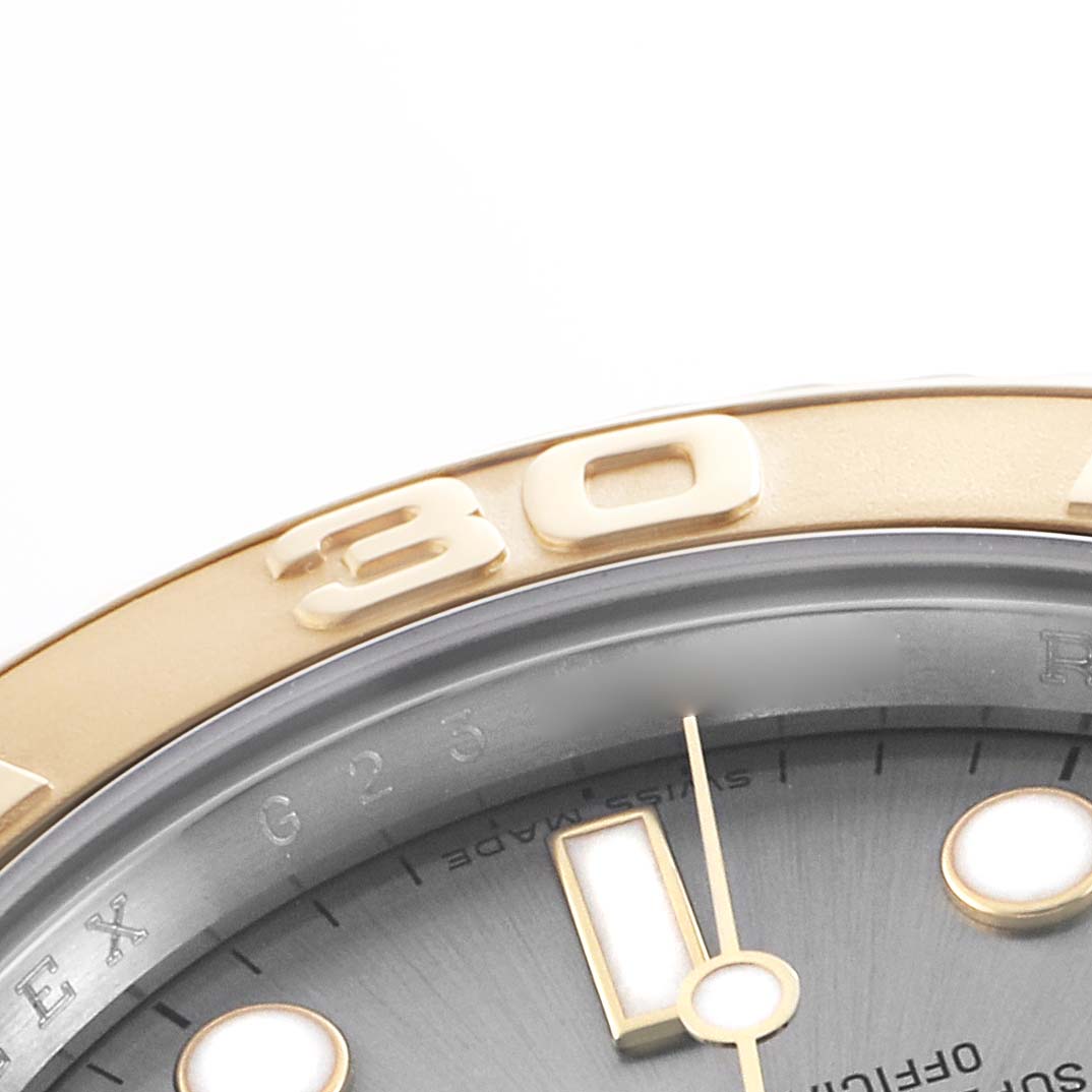 The image shows a close-up of the bezel and partial dial of a Rolex Yacht-Master 16623 Men's Steel and Gold (two tone) Grey Dial.