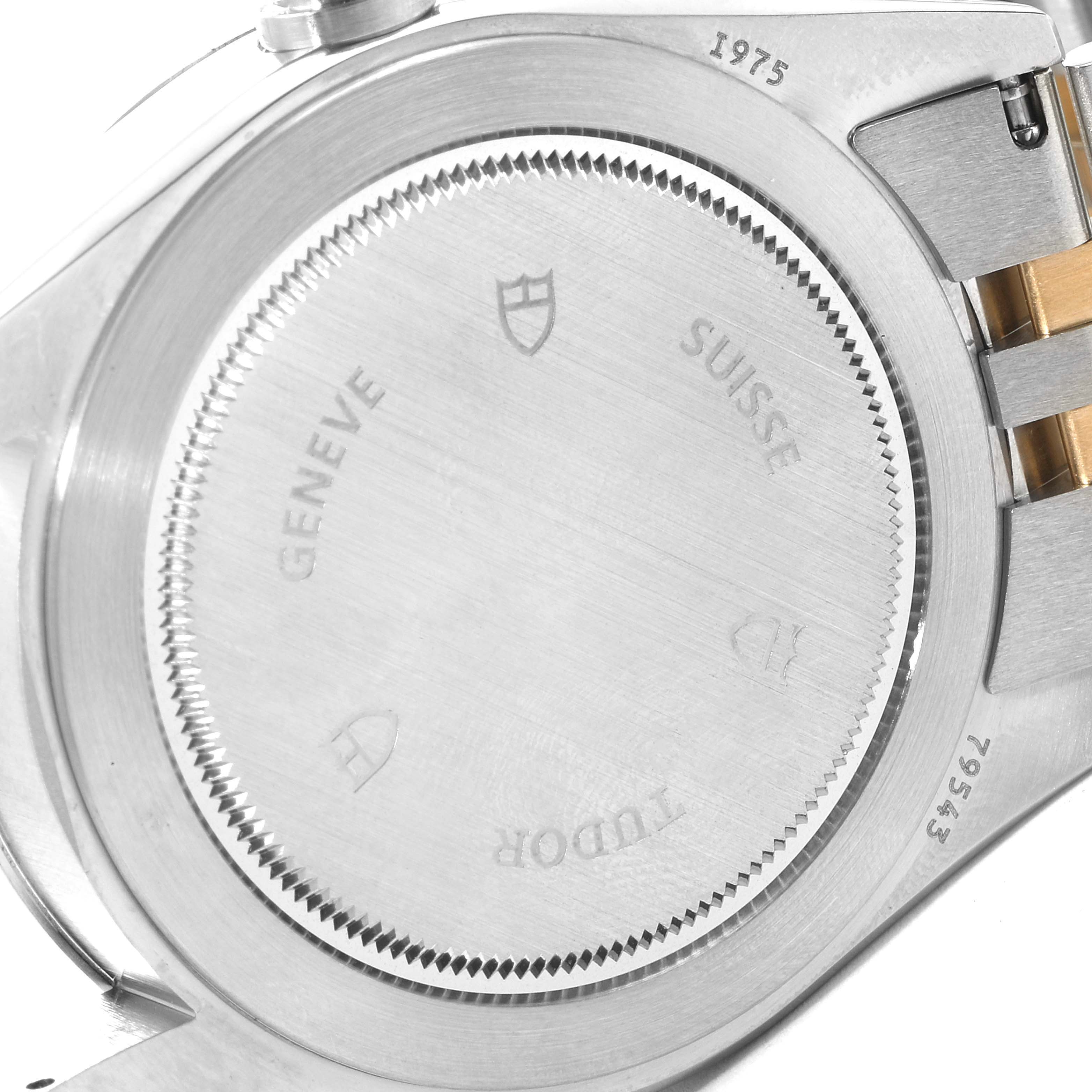 This image shows the case back of the Tudor Heritage Black Bay 79543 Men's Steel and Gold (two tone) Champagne Dial 79543 Men's Steel and Gold (two tone) Champagne Dial watch, displaying markings and part of the metal bracelet.