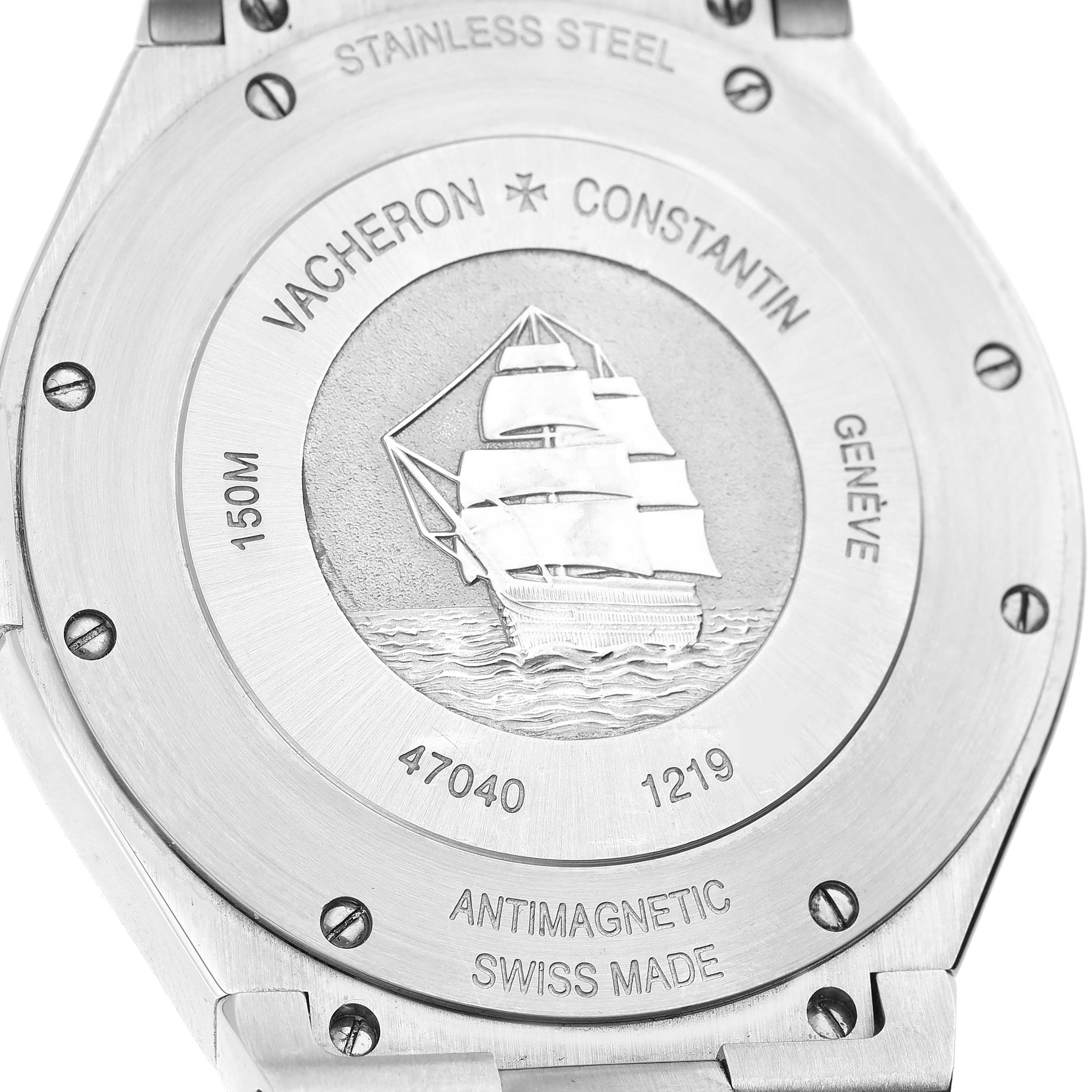 The image shows the back case of a Vacheron Constantin Overseas 47040/B01A-9094 Men's Stainless Steel Black Dial 47040/B01A-9094 Men's Stainless Steel Black Dial model watch with engravings and a ship design.