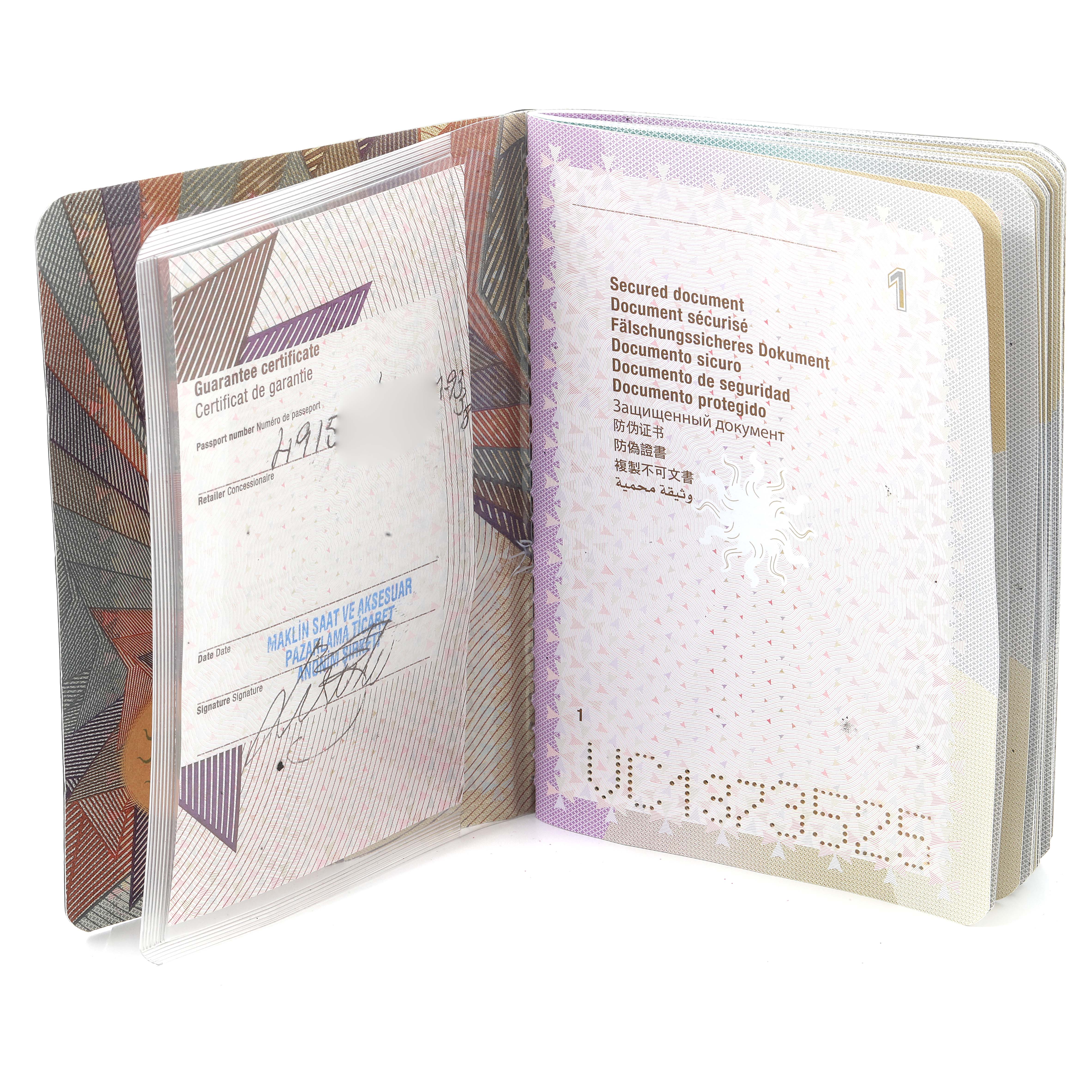 The image shows opened documents including the guarantee certificate for the Vacheron Constantin Overseas 49150/000M-9338 Men's Steel and Gold (two tone) Grey Dial 49150/000M-9338 Men's Steel and Gold (two tone) Grey Dial model watch.