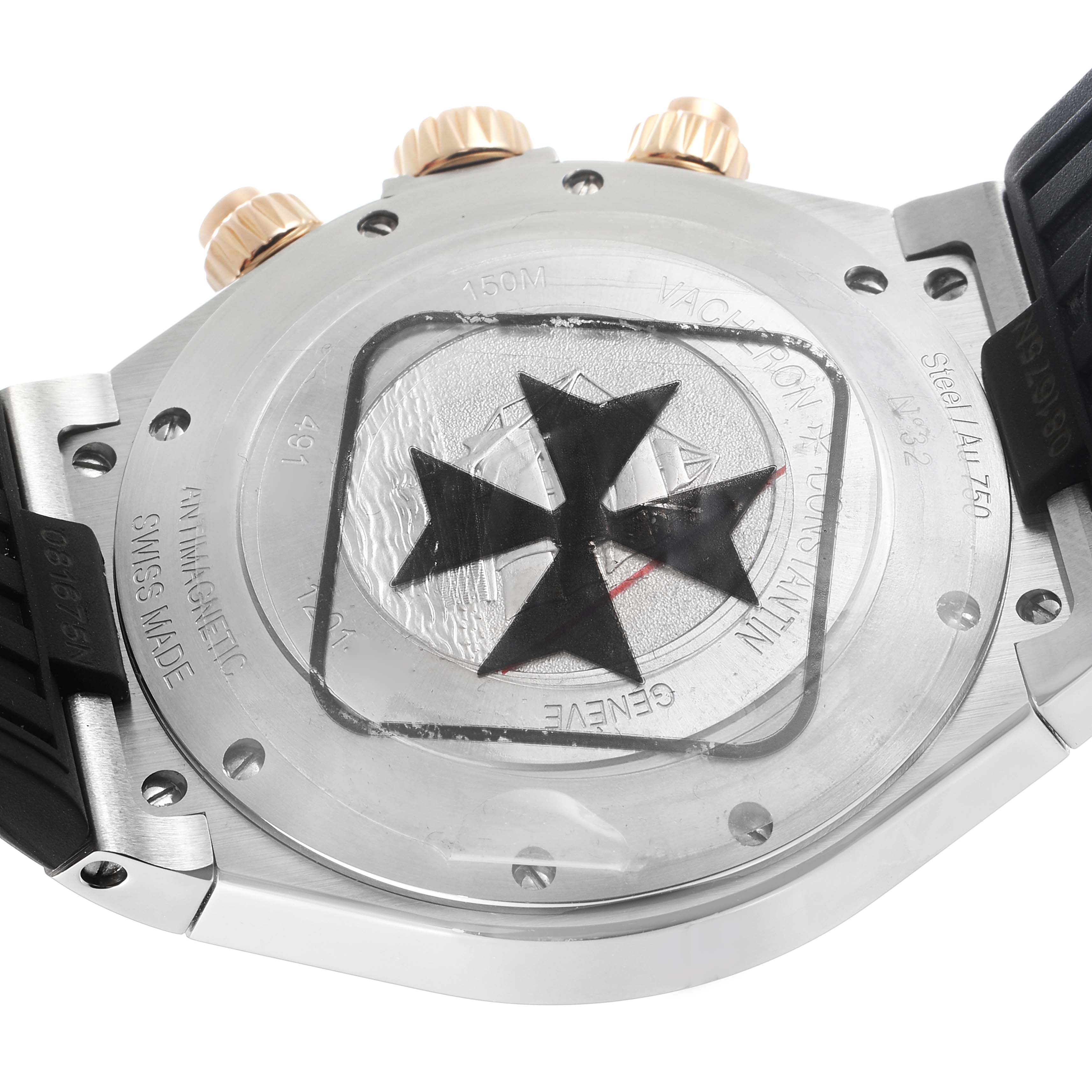 The image shows the back case of a Vacheron Constantin Overseas 49150/000M-9338 Men's Steel and Gold (two tone) Grey Dial 49150/000M-9338 Men's Steel and Gold (two tone) Grey Dial watch, including its screws, crown, and strap.